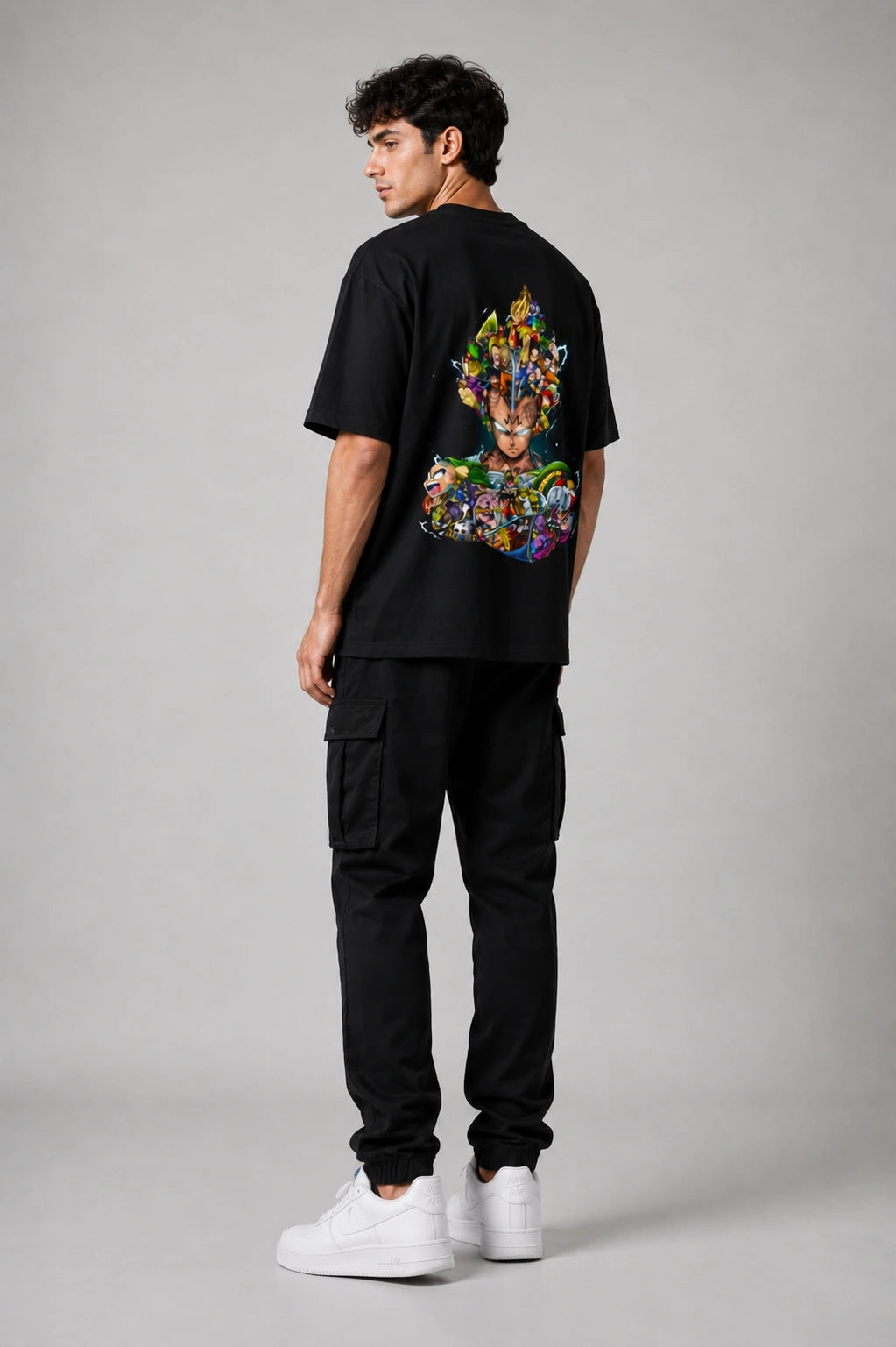 Model wearing STORKK Core Oversized T-Shirt in Black showing the back graphic design.
